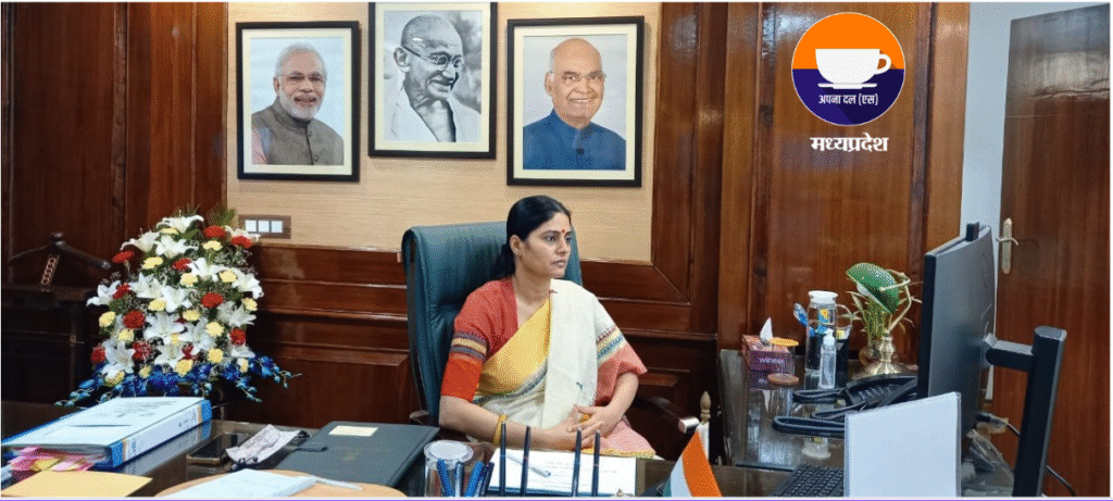 Union Minister Anupriya Patel seated at her office desk in Madhya Pradesh, with portraits of prominent leaders in the background, overseeing the approval of 48 projects to ensure the uninterrupted supply of critical Active Pharmaceutical Ingredients (APIs) in India, promoting pharmaceutical self-reliance.